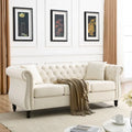Canapé 3 places Chesterfield en velours beige, accoudoirs arrondis, garniture cloutée, structure en bois