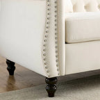Canapé 3 places Chesterfield en velours beige, accoudoirs arrondis, garniture cloutée, structure en bois