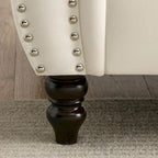 Canapé 3 places Chesterfield en velours beige, accoudoirs arrondis, garniture cloutée, structure en bois